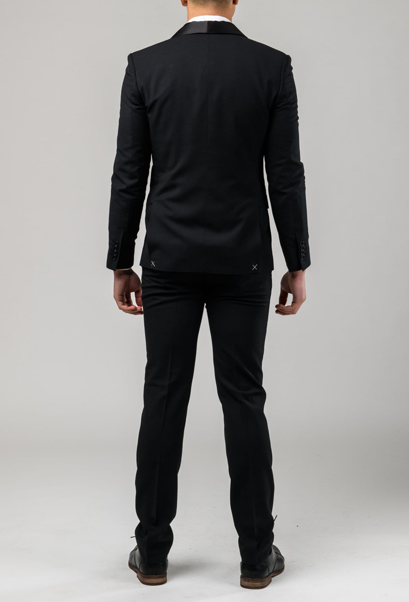 A reverse view of the slim fit laneport suit by Aston in black A019301S showing the jacket double vent detail
