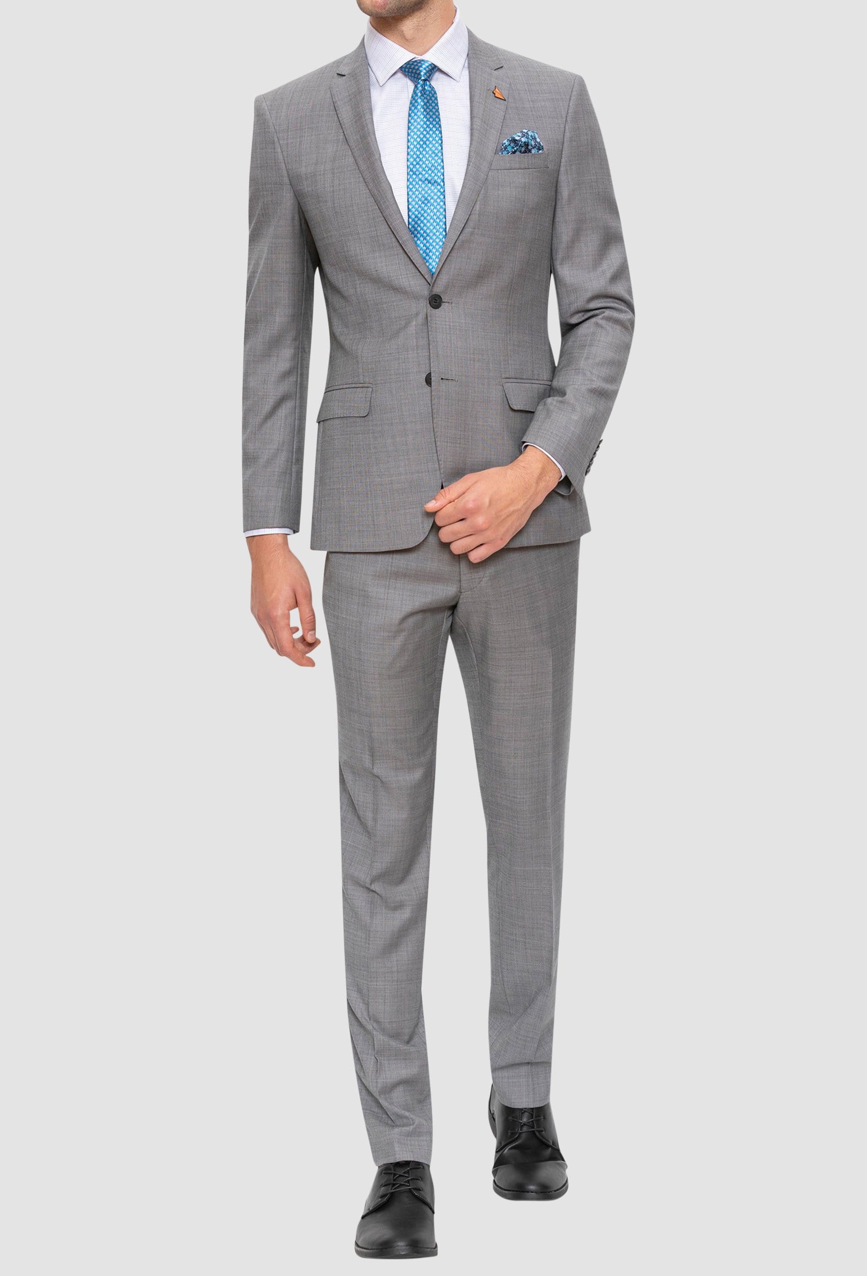 A full length up view of the Gibson slim fit lithium suit in grey pure wool FGE645 styled with a white shirt and blue tie