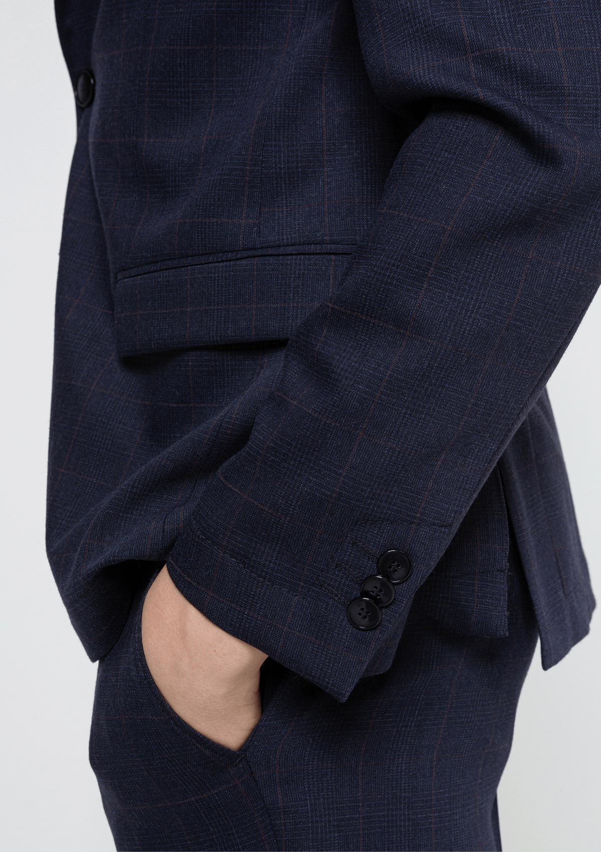 a close up of the side of a model wearing the anfred hugo boss mens suit, the models hand is inside the trouser pocket