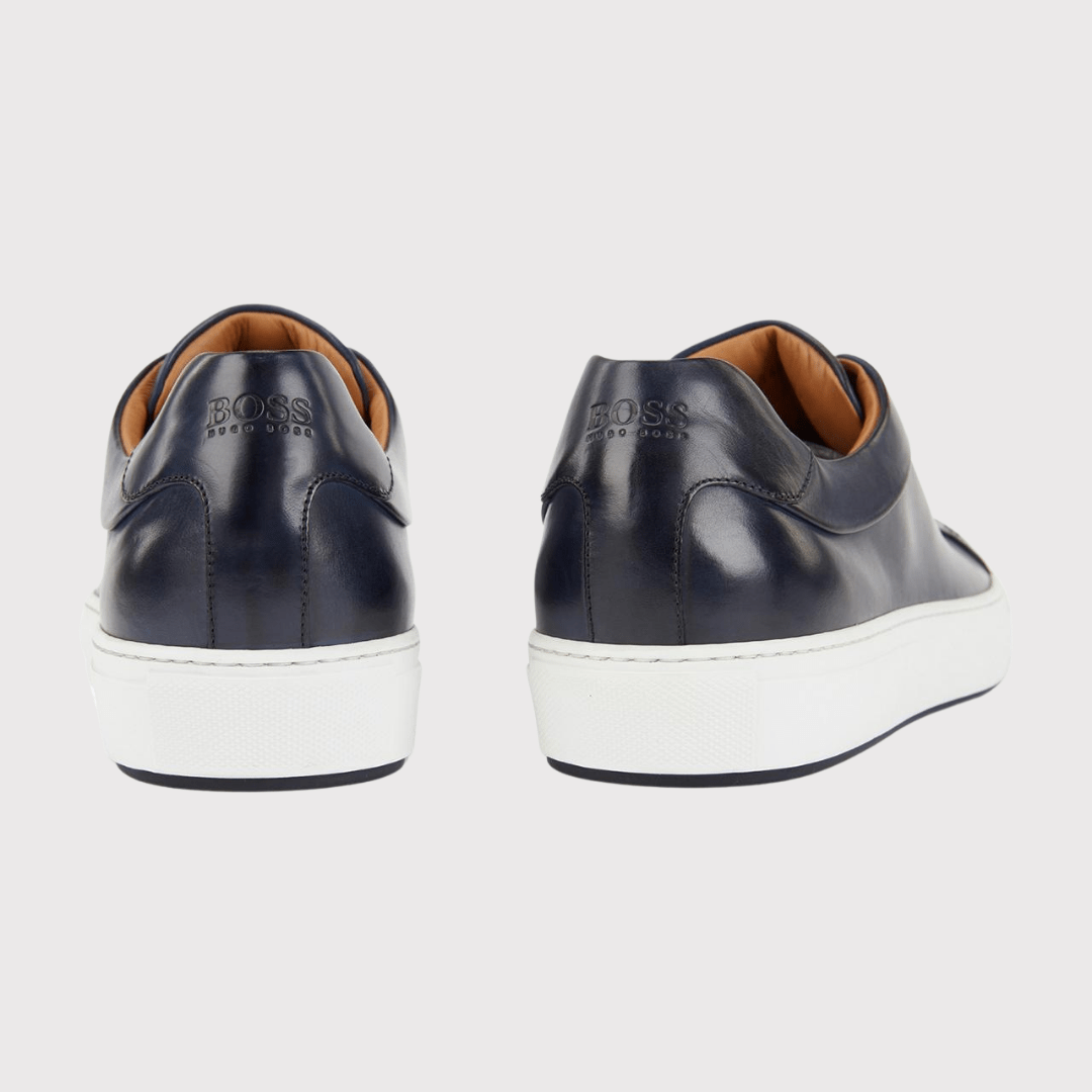 the back of the hugo boss mens mirage tenn trainers in navy italian leather showing the embossed logo on the heel
