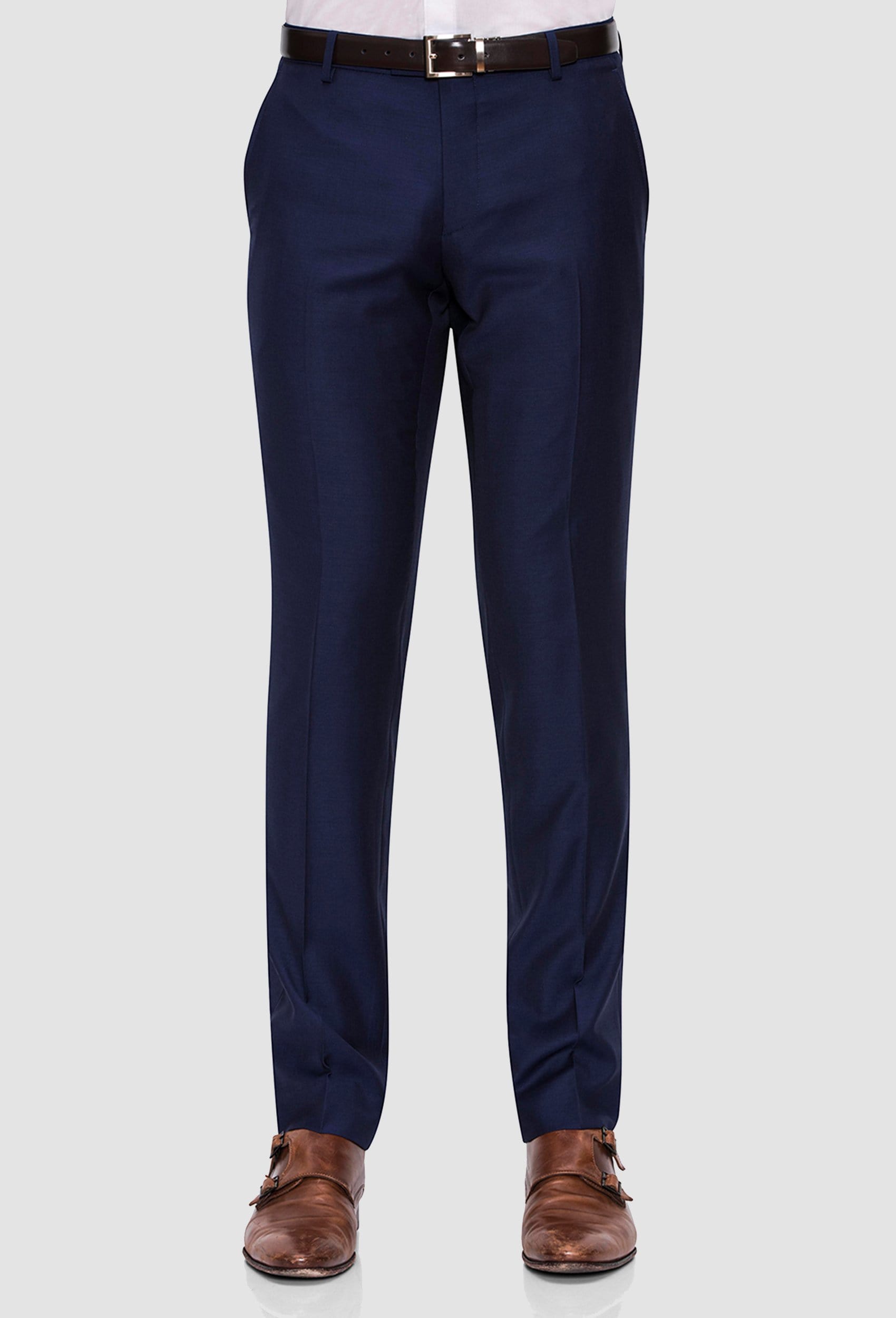 A close up view of the Joe Black slim fit anchor suit trouser in navy pure wool FJY100 styled with a brown belt