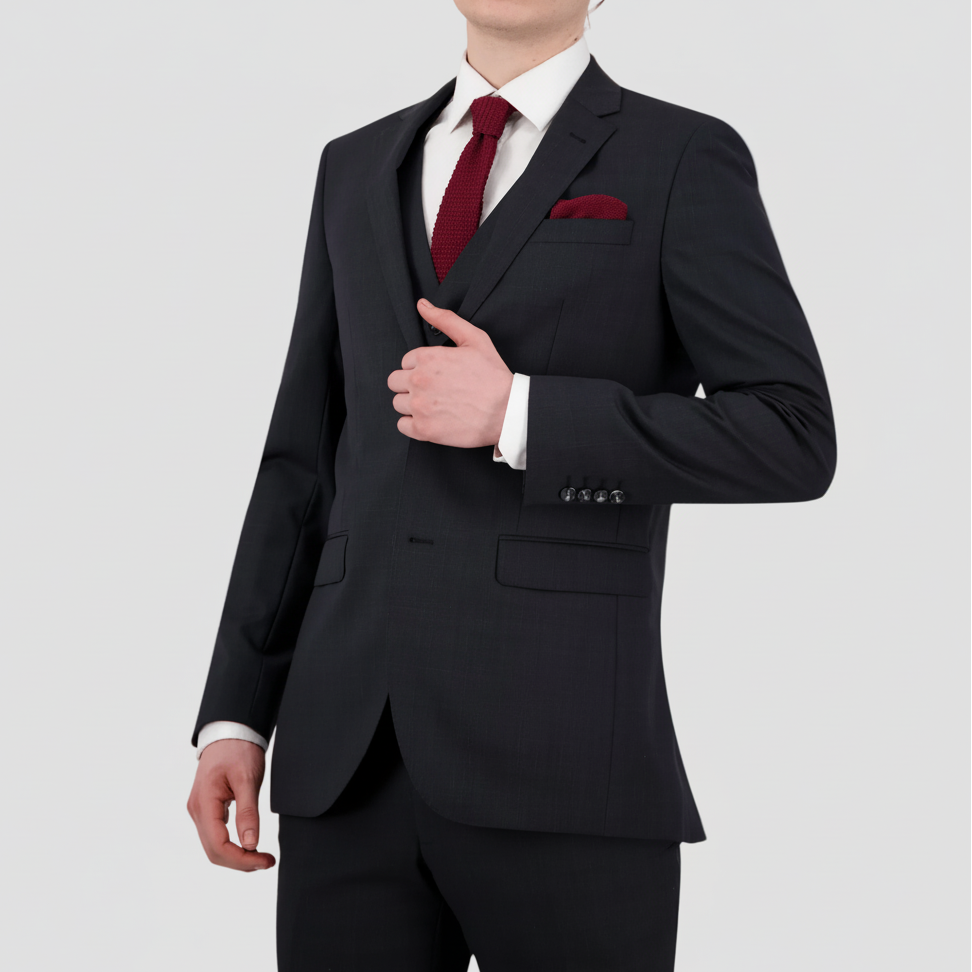 Patterned charcoal mens wool blend suit by Savile Row with a white shirt, maroon tie and pocket square.