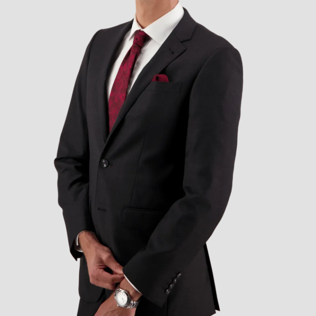 Charcoal travel‑finish wool suit by Savile Row, tailored in Super 110’s Merino for structure and ease.