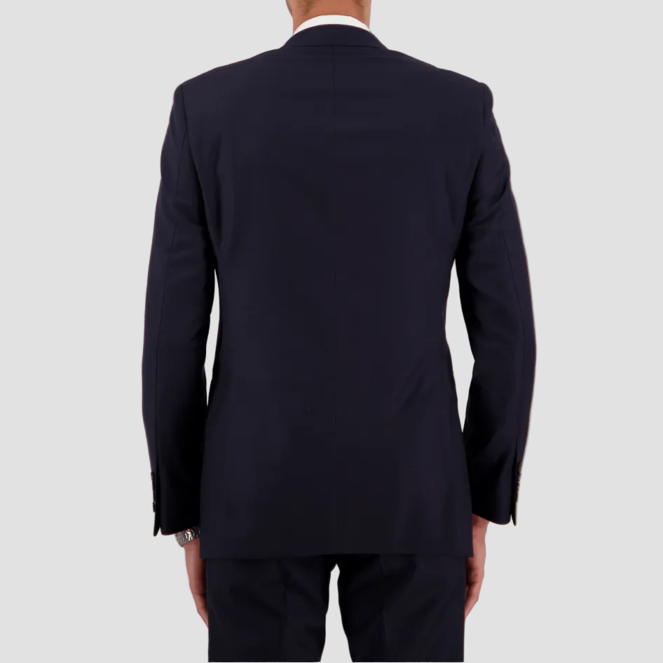 Savile Row’s tailored navy travel‑finish suit, crafted in Super 110’s Merino with a crisp two‑button front and double vent at the back.