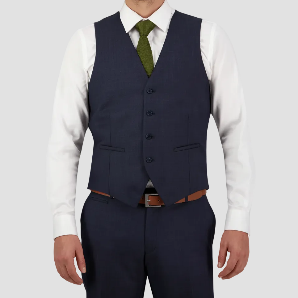 Navy blue Australian merino wool vest paired with matching pants, white shirt, olive-green tie and brown leather belt.