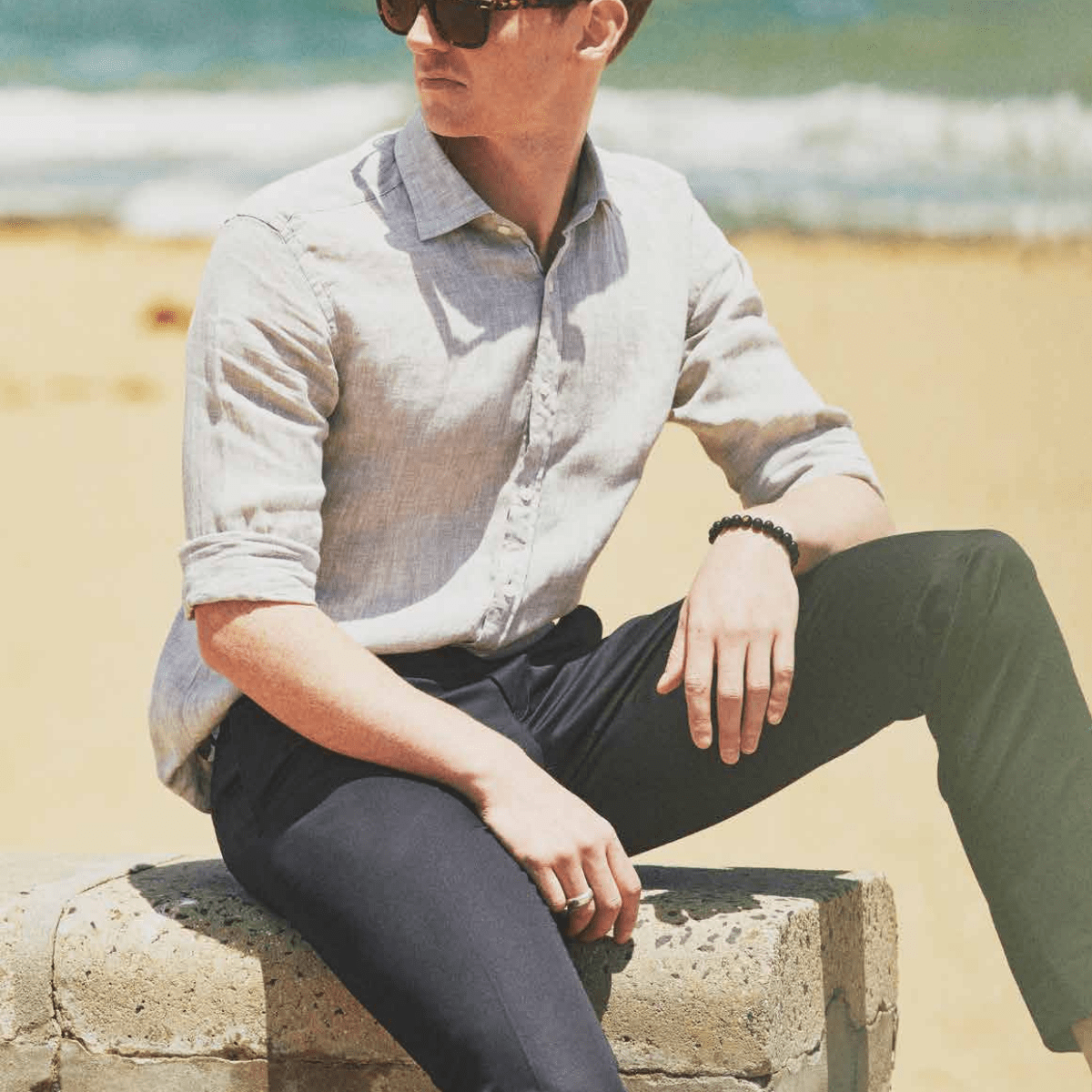 a man wears the sage mens linen shirt by studio italia