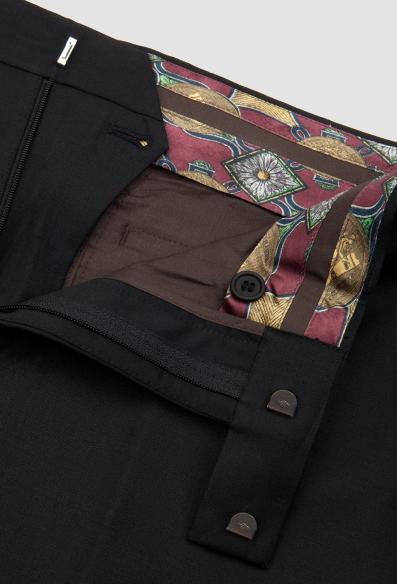 a close up view of the waistband printed lining and hook and eye fastener on the ted baker slim fit twilite suit trouser in black pure wool
