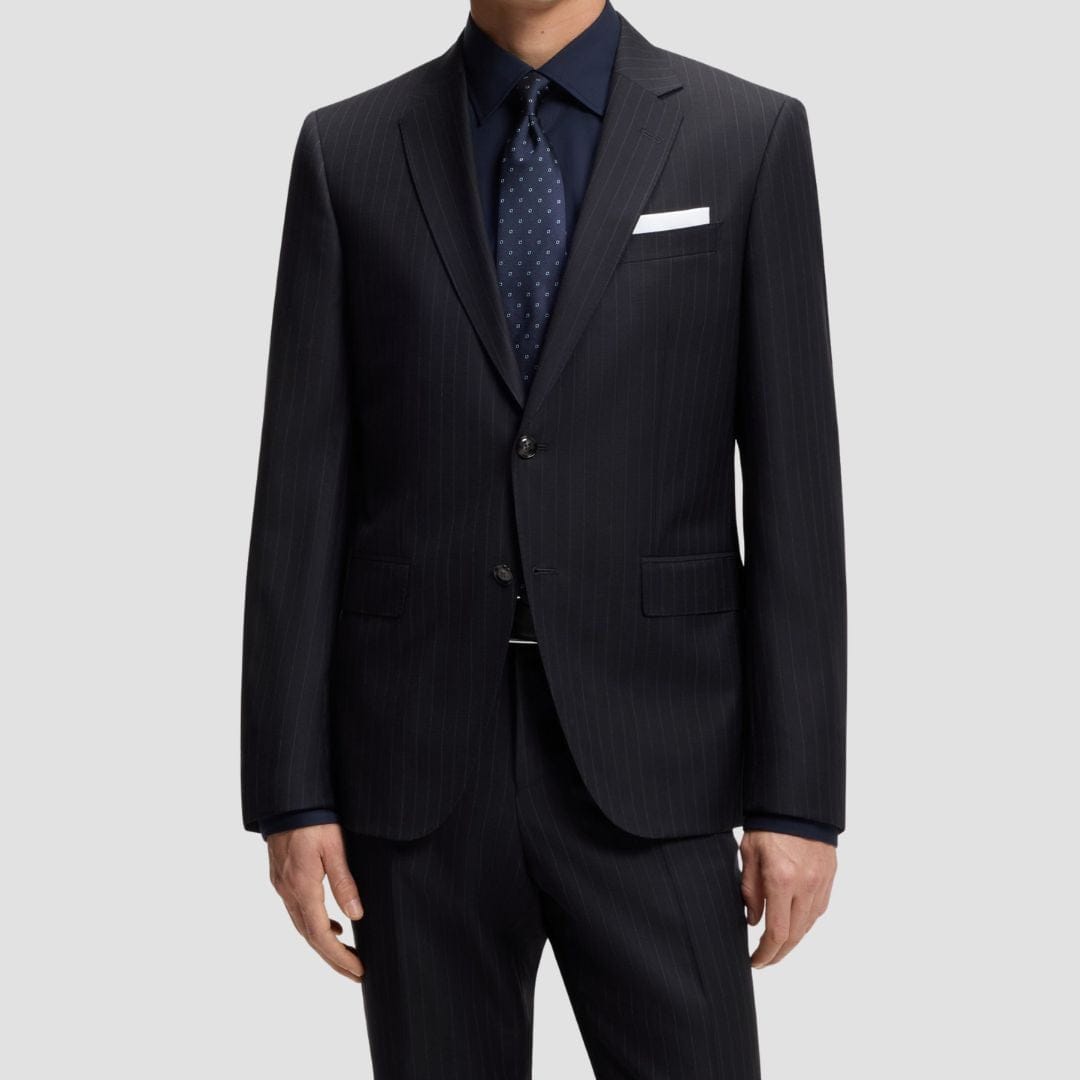 Black suit with a navy shirt and patterned tie 
