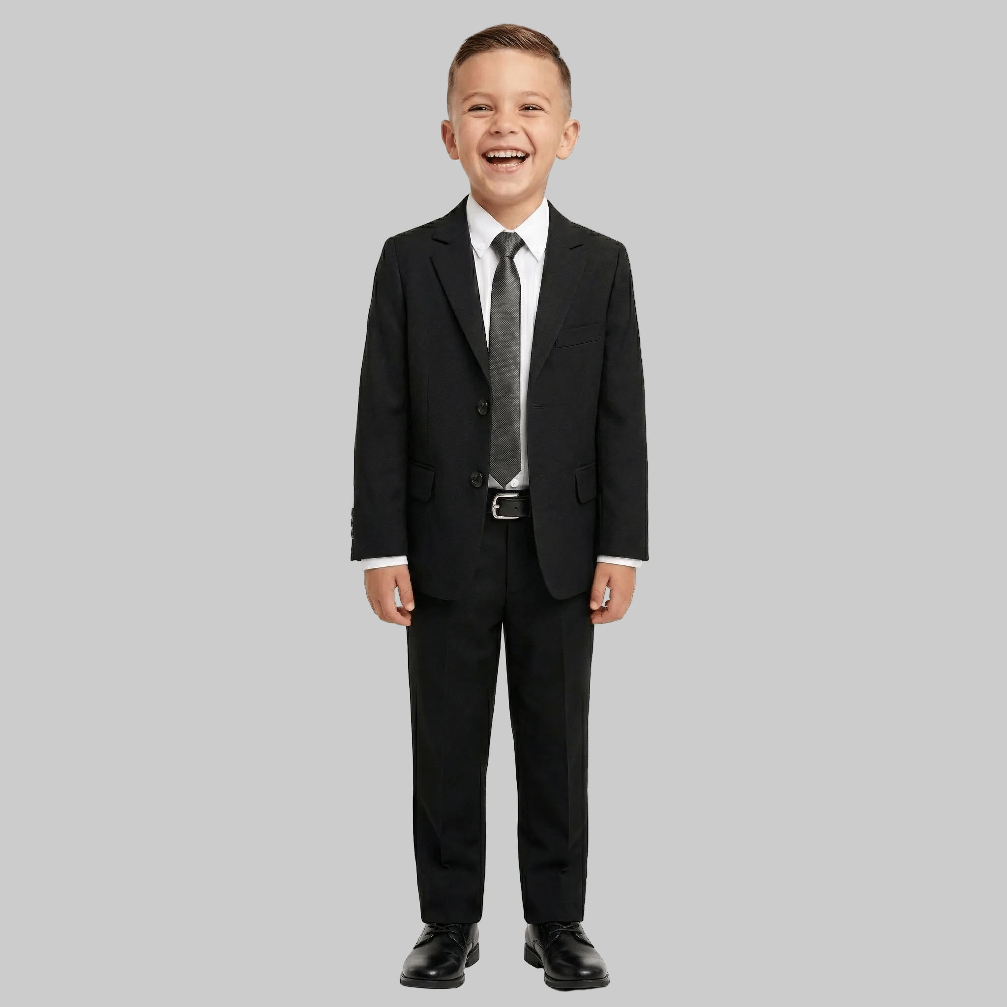 Child wearing a black suit with a gray tie on a white background