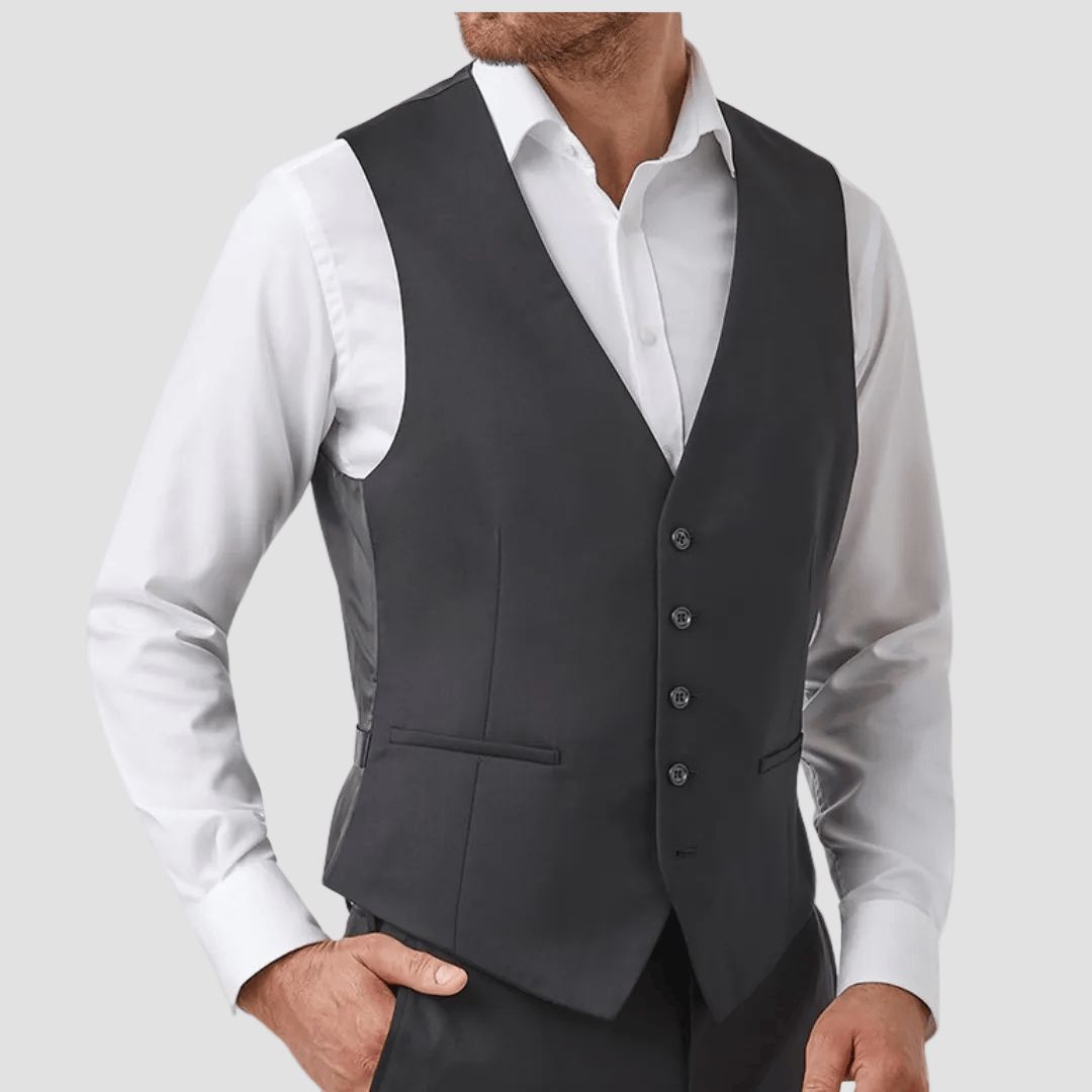 Man wearing a black vest over a white shirt 