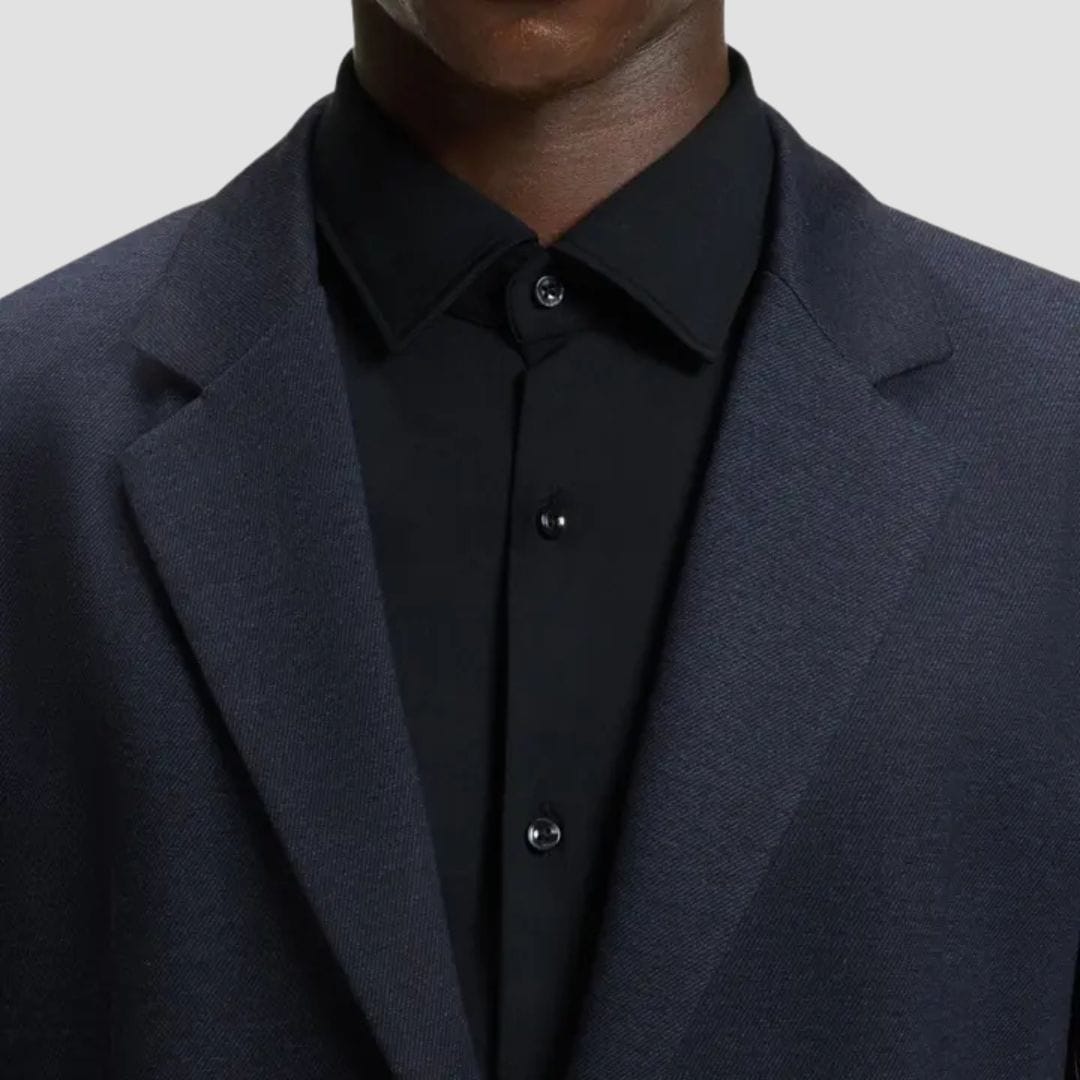 Navy blazer over a black shirt 