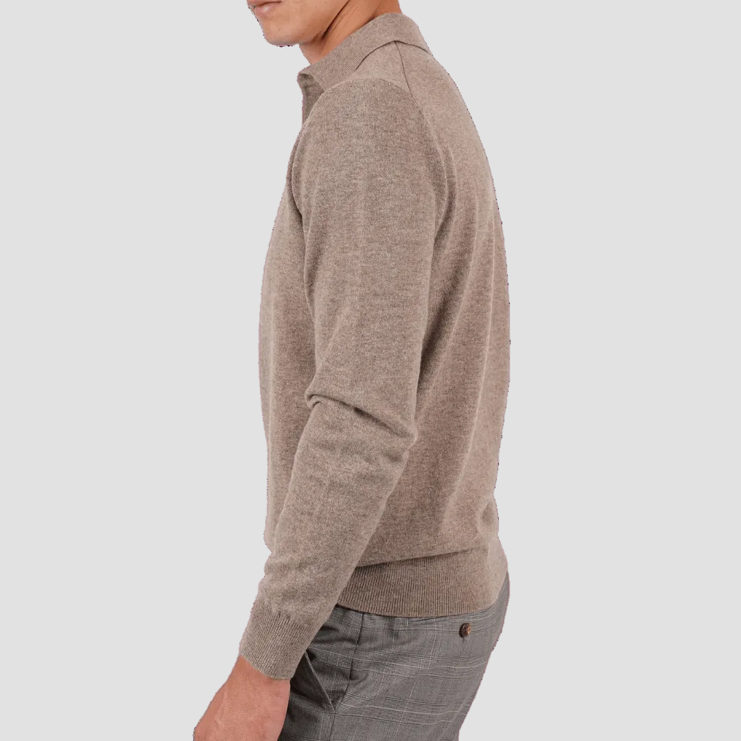 Person wearing a brown sweater and gray pants on a transparent background