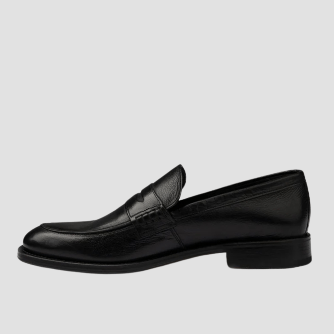 Black loafer shoe on a light gray background