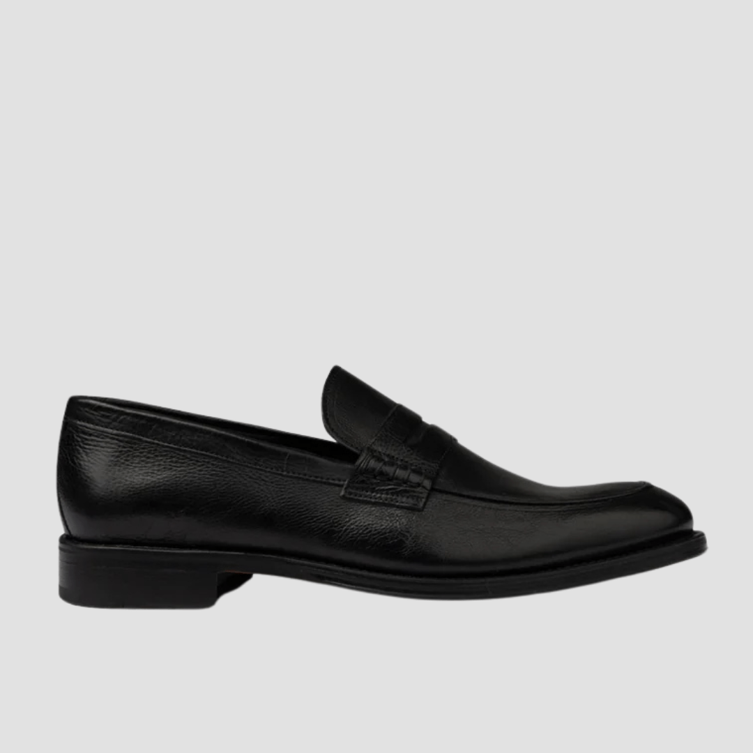 Black loafer shoe on a light gray background