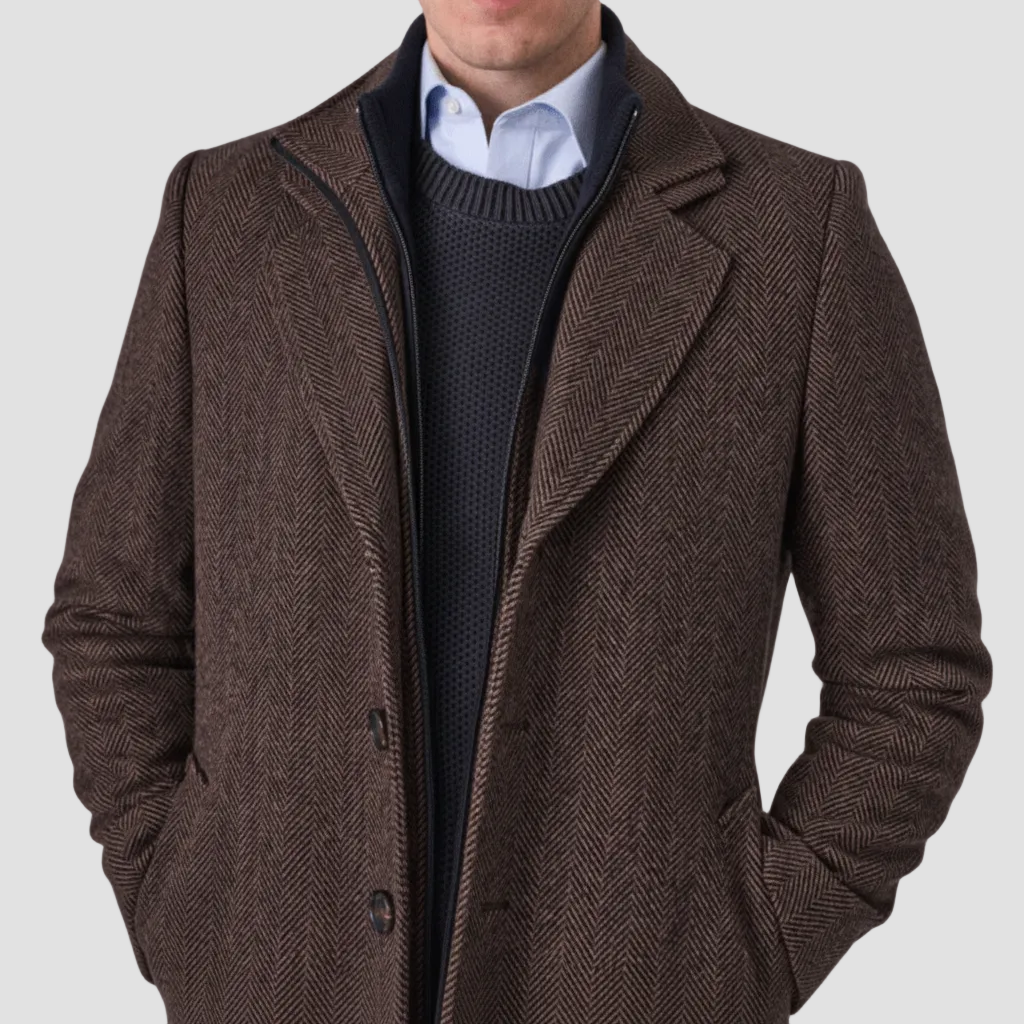 Brown coat with removable collar by Savile Row, with a blue knit jumper and light blue shirt.