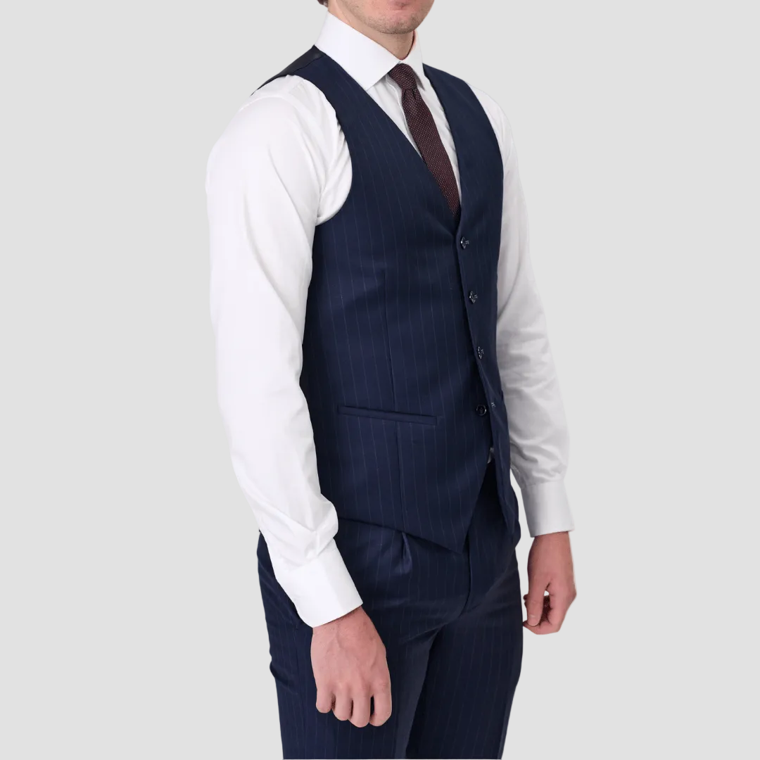 Man wearing a navy pinstripe suit vest by Savile Row with a white shirt and maroon tie.