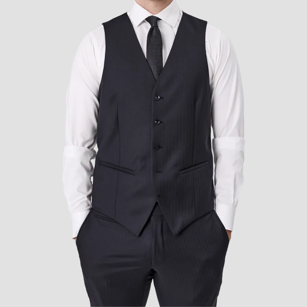 Tasmanian Wool vest with four buttons, jetted pockets and satin backing, paired with matching pants, white shirt and patterned tie.
