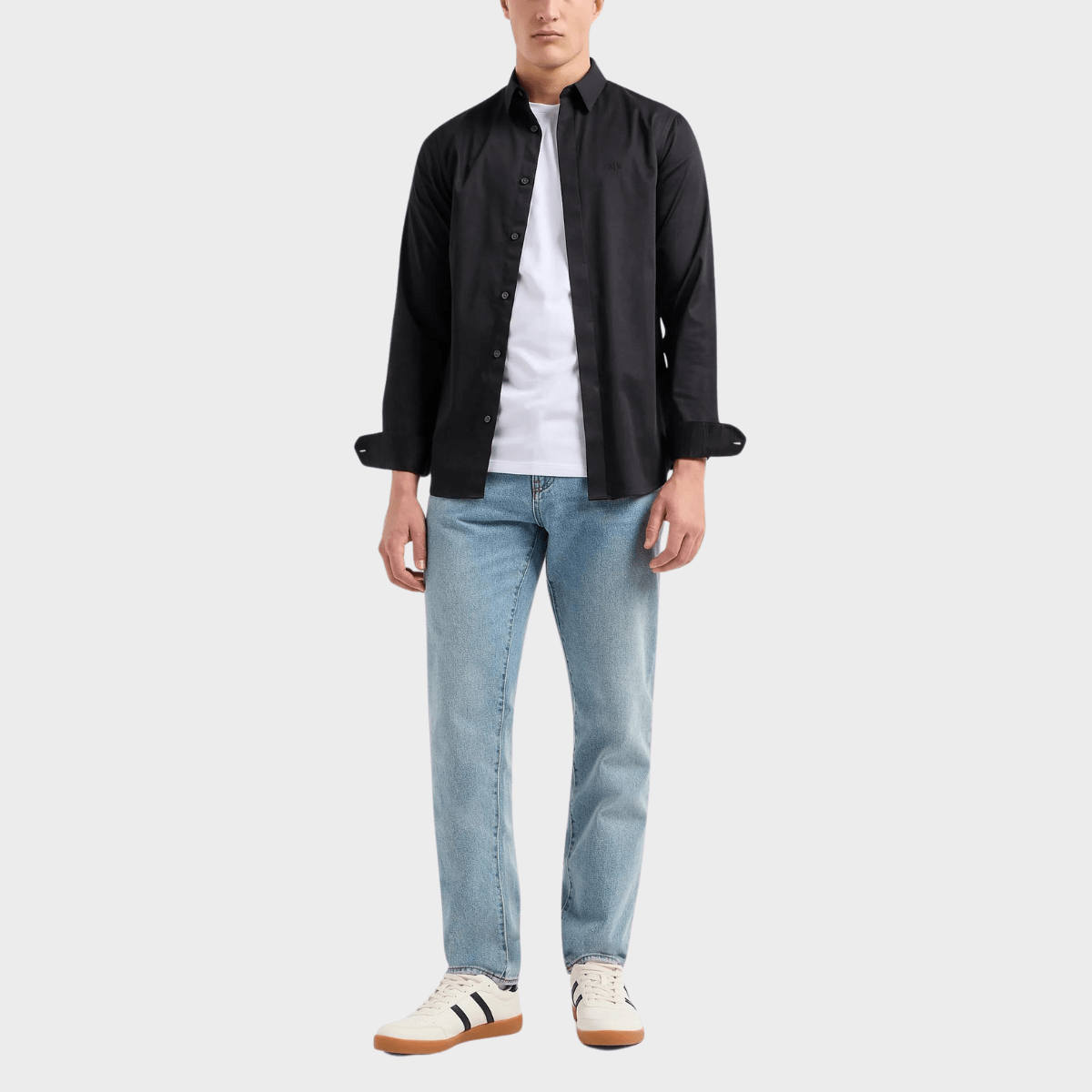 Styling the white casual shirt with black long sleeve shirt and jeans