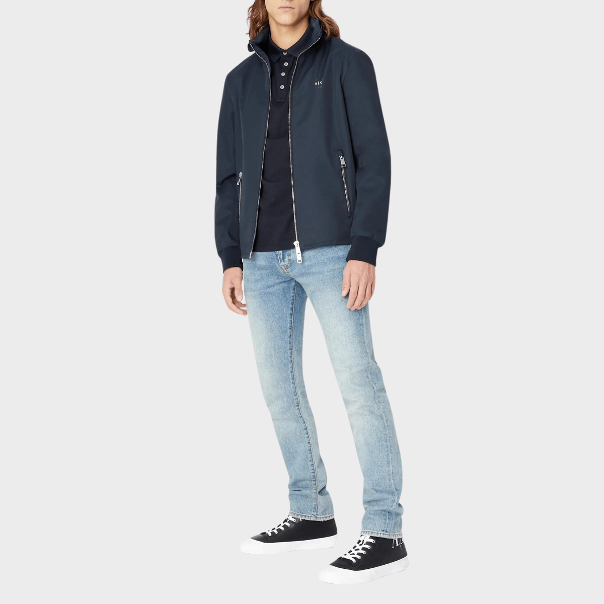 The navy polo shirt by Armani styled with a bomber jacket and jeans.