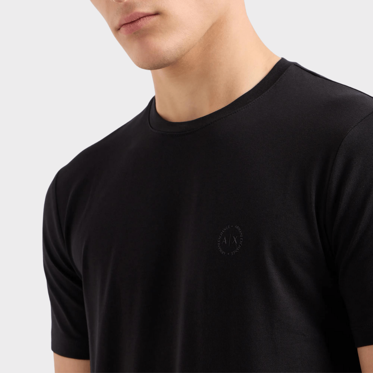 A closer look at the round crew neck of this black shirt by Armani