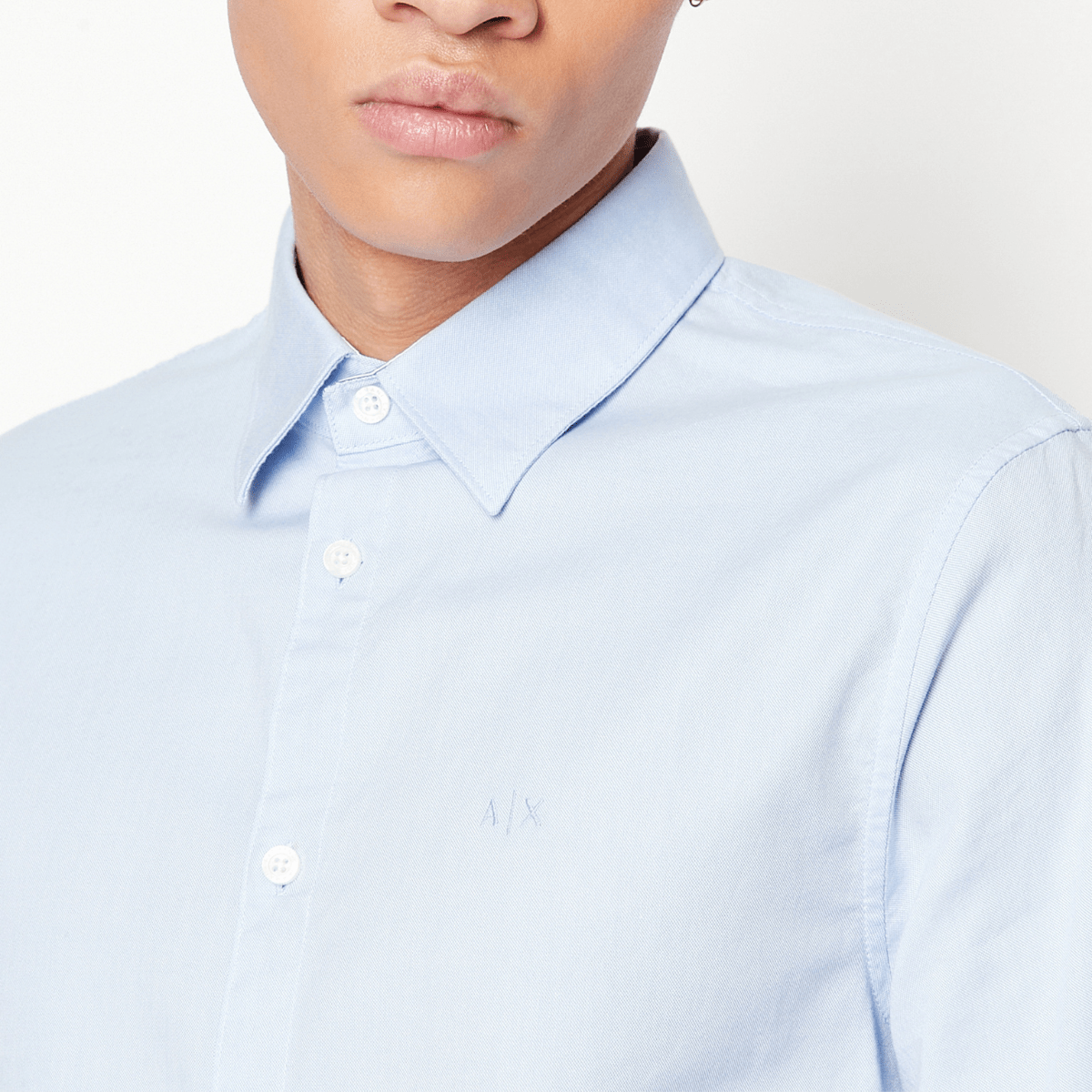 The collar and button details of the Armani slim fit oxford business shirt in light blue.