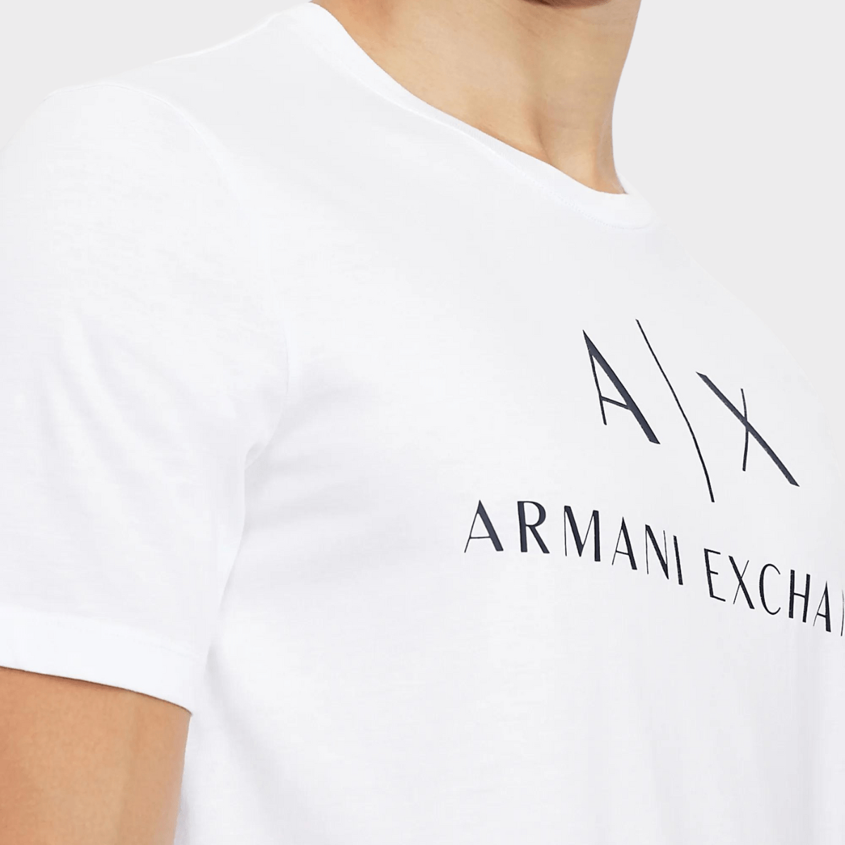 Closer look at the logo of the slim fitted crew neck shirt by Armani in white.