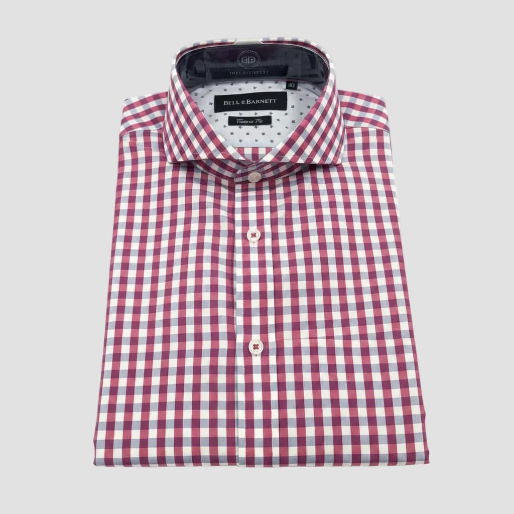 Red and white checkered shirt with a brand tag on a clear background