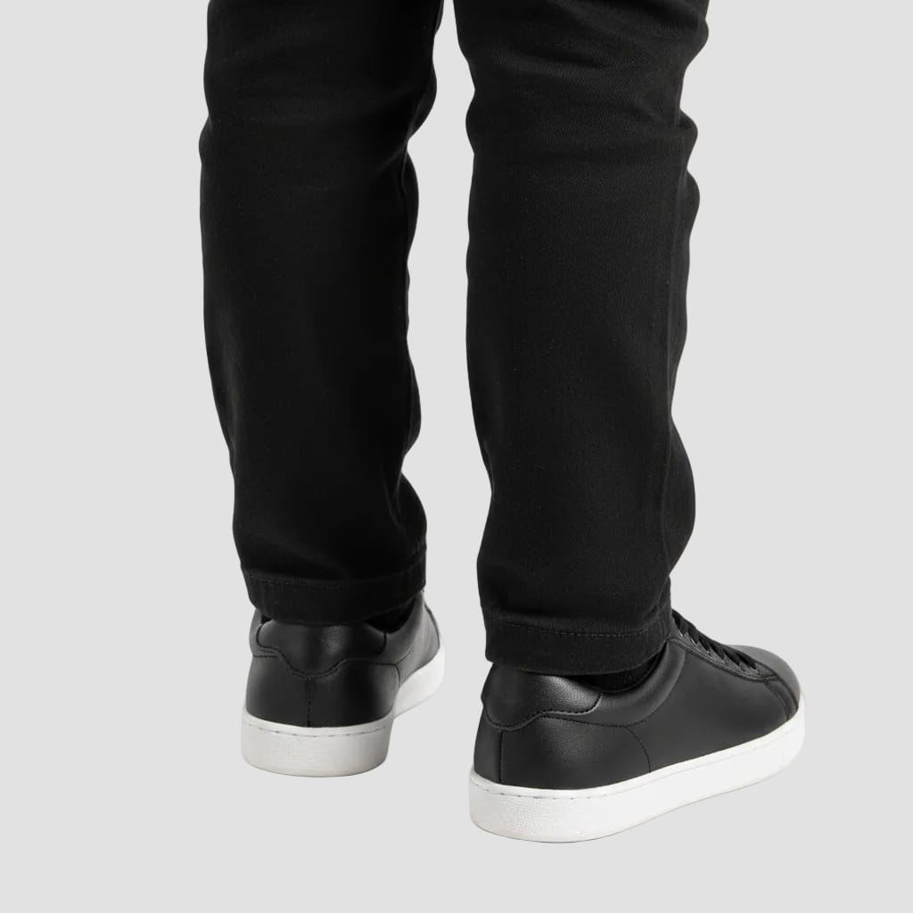 back of black sneakers with white sole