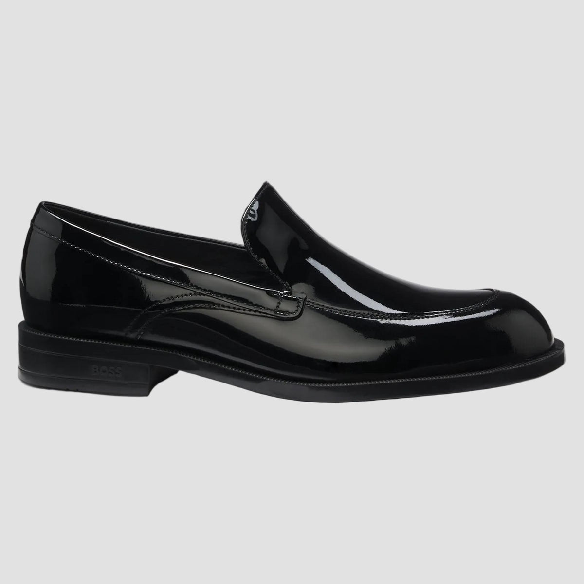 A slip-on canvas sneaker featuring a bold black and white organic abstract pattern, set against a clean white background.