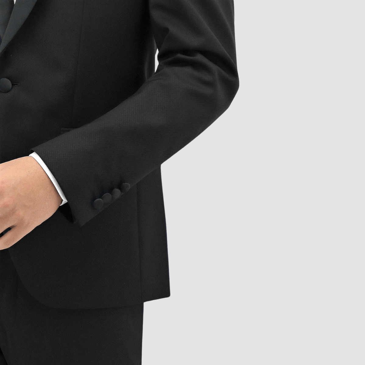 Men’s black shawl‑lapel tuxedo by Boston, crafted in textured merino wool with satin detailing and slim‑fit trousers.