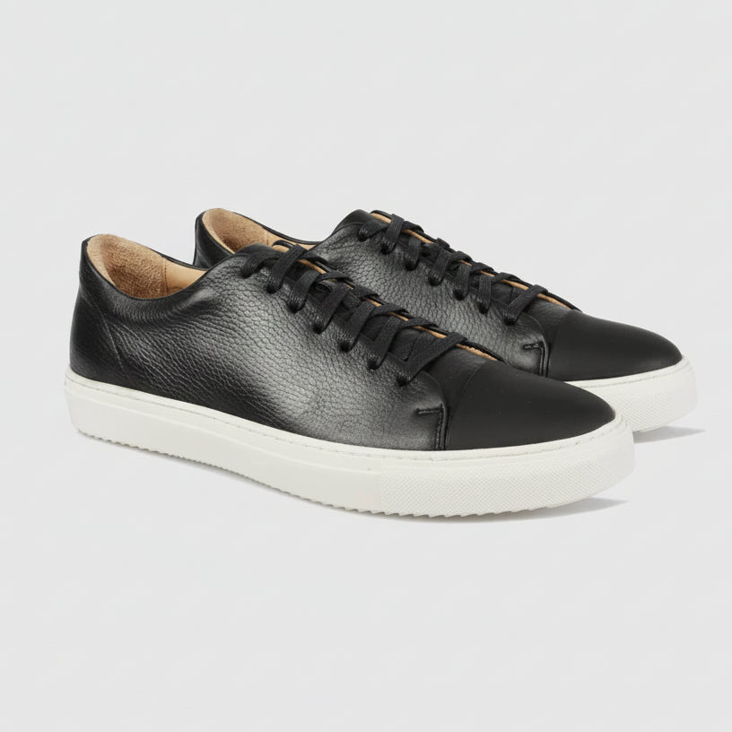 Men’s Barry black leather sneakers by Brando, featuring a pebbled shine finish, matte toe and thick white sole.
