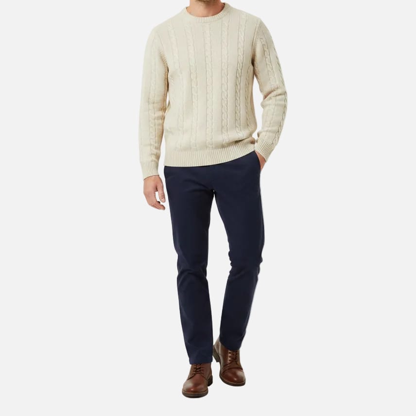 Beige cable knit sweater on a white background