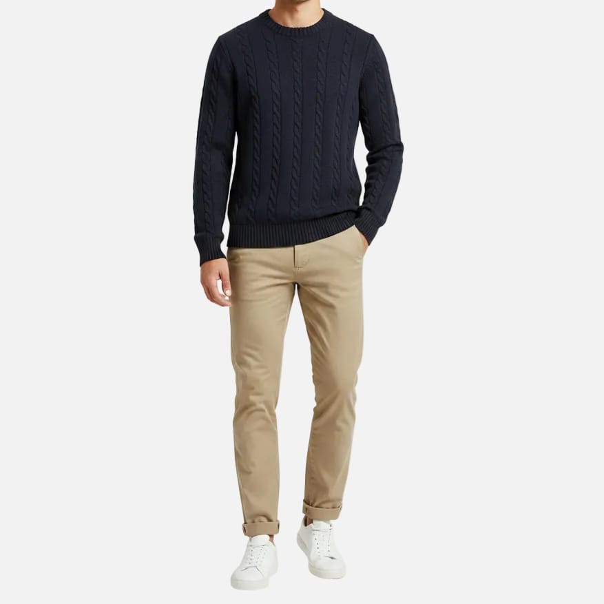 Navy blue cable knit sweater on a white background