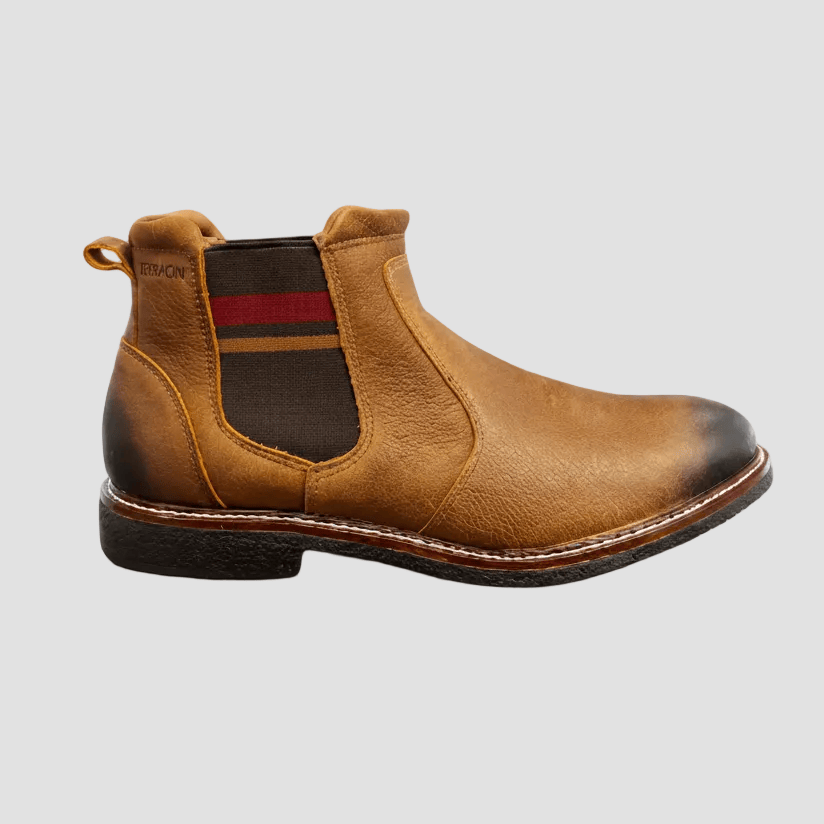 Brown leather Chelsea boot with a red stripe on a white background