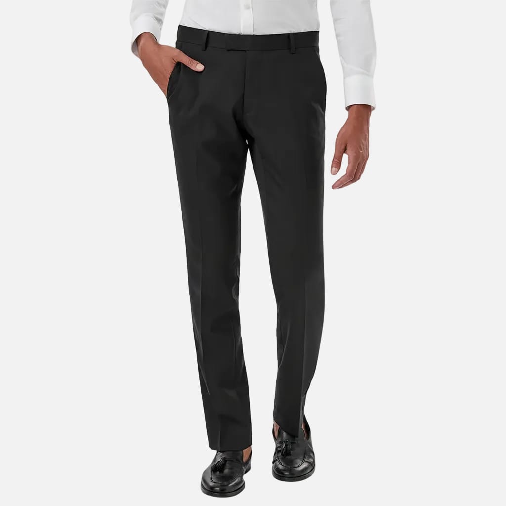 Person wearing black dress pants with a white shirt on a light gray background