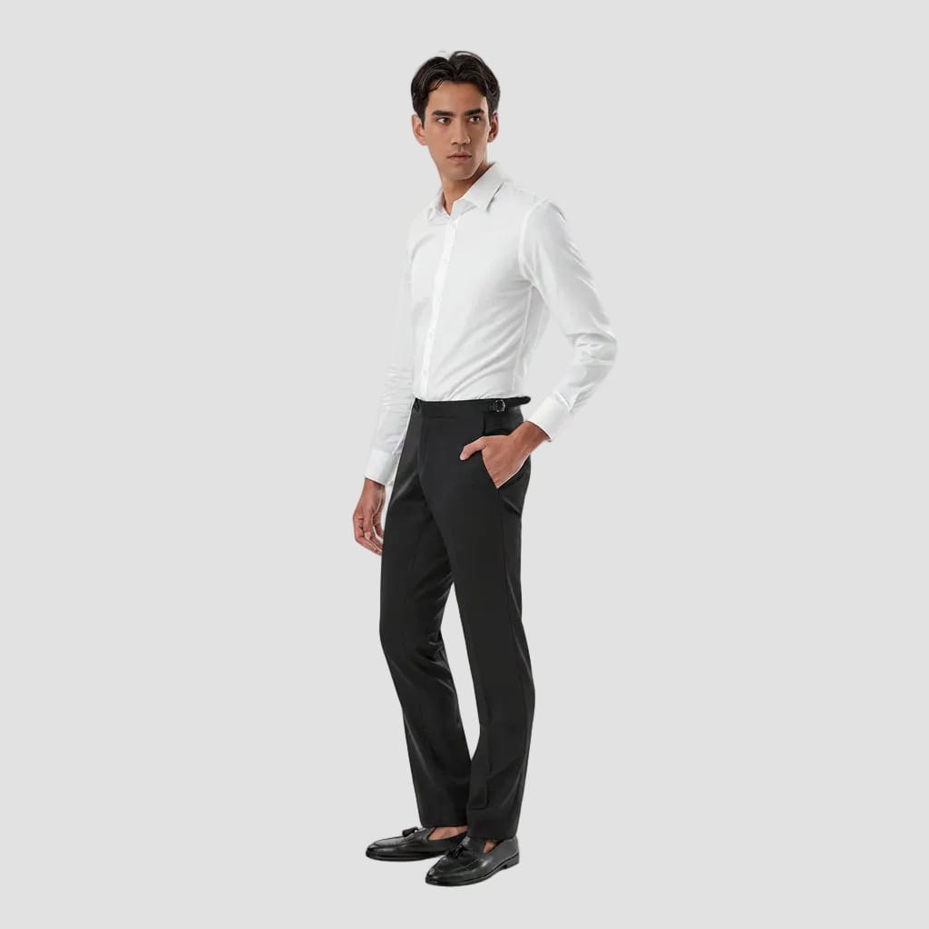 A man modeling a white long-sleeve button-down shirt tucked into black dress pants with a black belt, paired with black loafers, against a solid white background.