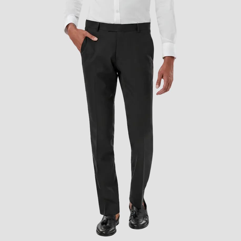 Person wearing black dress pants with a white shirt on a light gray background