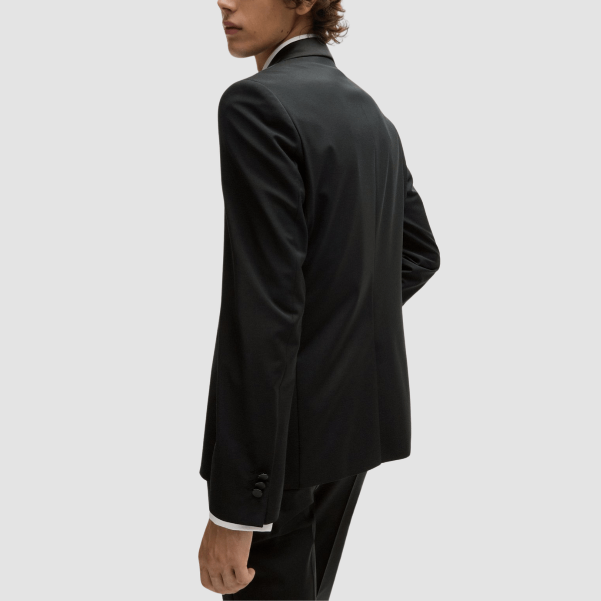 The Arti‑Getlin black tuxedo by Hugo—super slim fit, satin trims, and shawl lapel.