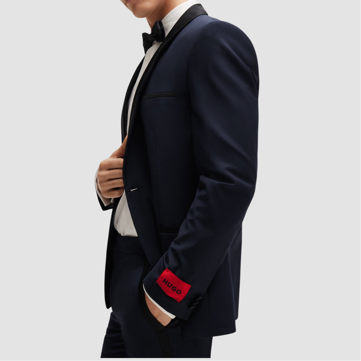 The Arti‑Getlin dark blue tuxedo by Hugo—super slim fit with black satin trims and shawl lapel.
