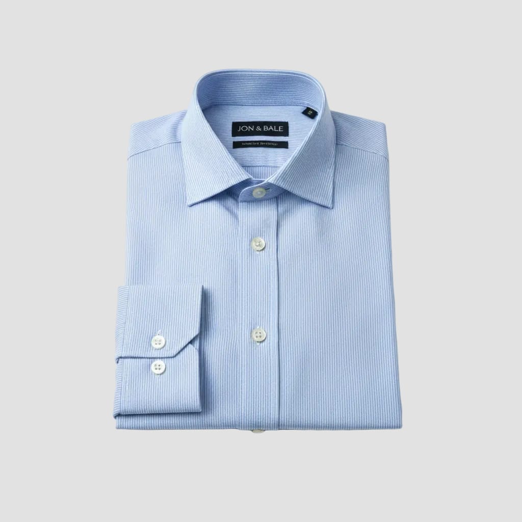 Blue striped shirt in packaging with 'Jon Bale' branding.