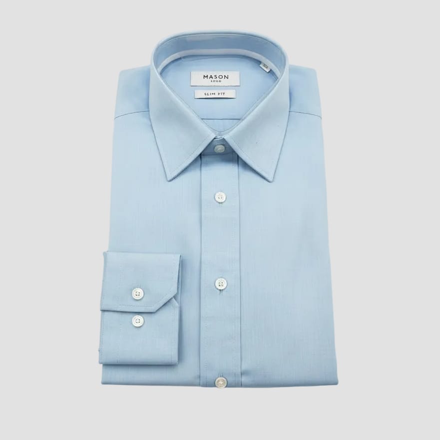 Light blue dress shirt with 'Mason' branding held by a hand against a blurred background of other shirts.