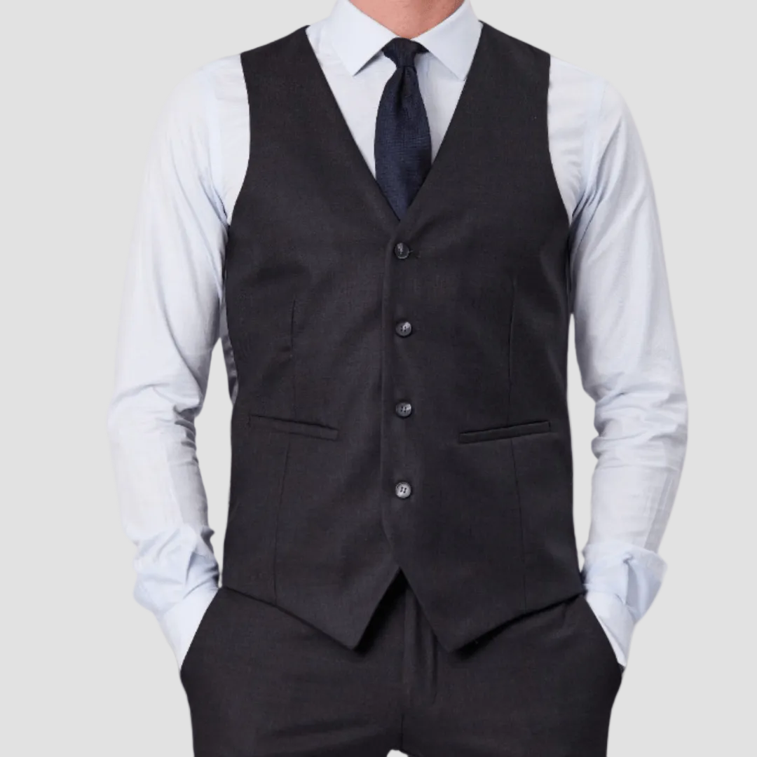 Charcoal vest by Savile Row over a white shirt with a navy tie