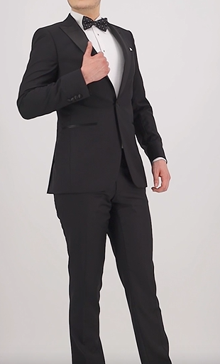 Black travel‑finish wool trouser by Savile Row in a classic fit, tailored from Super 110’s Merino, with matching tuxedo jacket, white shirt, bowtie and black leather shoes.