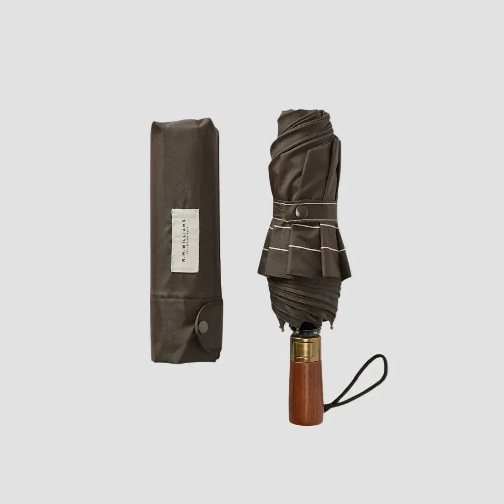 Foldable umbrella with wooden handle and branded packaging on a white background