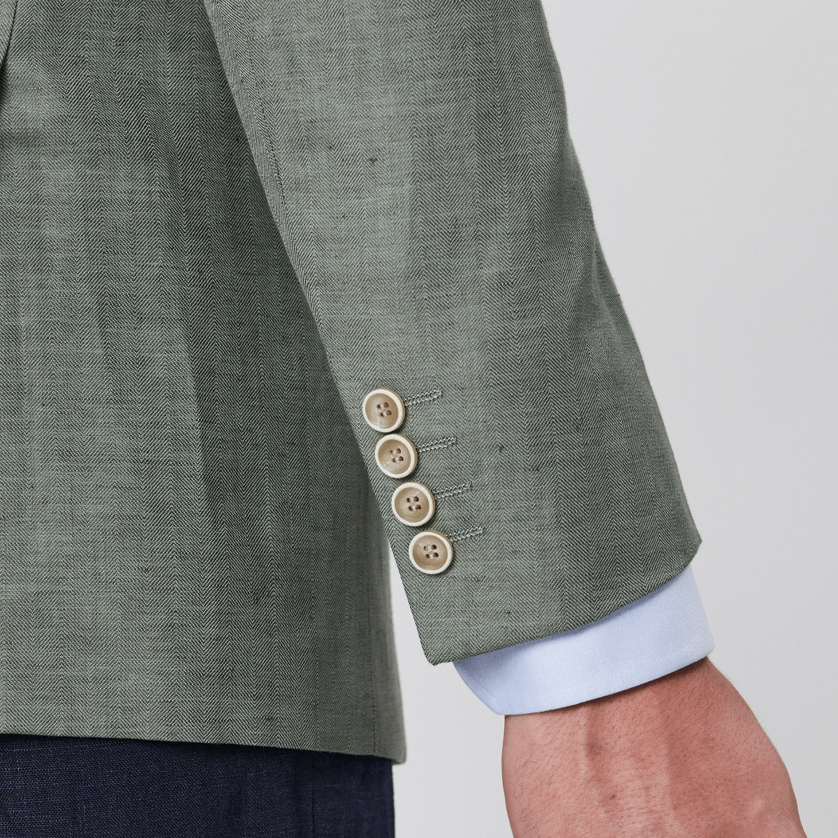 Green linen blend sports jacket and a four buttoned sleeve.