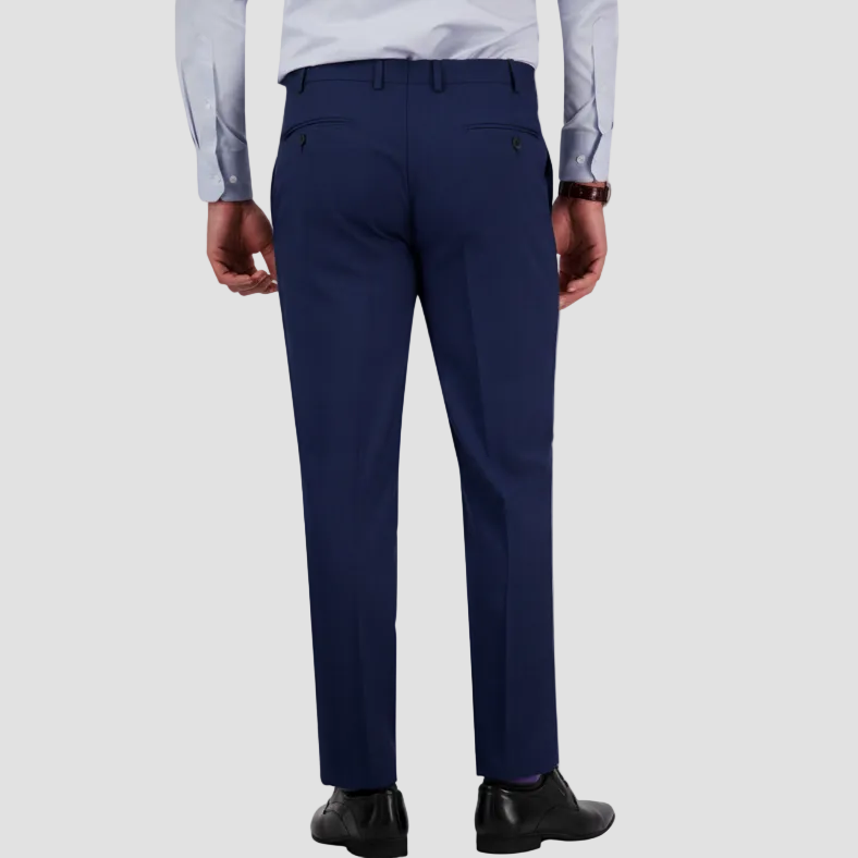 Denim-blue dress pants by Savile Row worn by a person with a white shirt and black shoes.