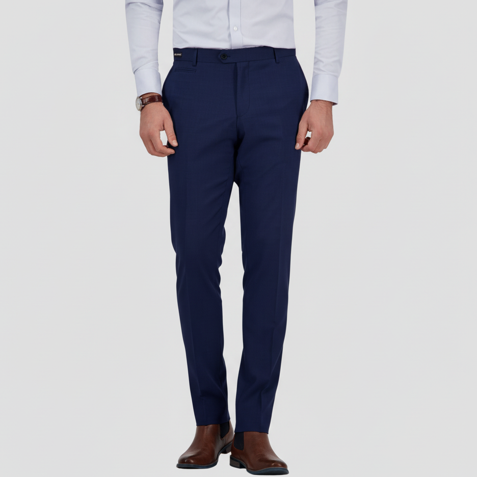 A man wearing a demin-blue suit trouser by Savile Row with a white shirt and brown shoes.