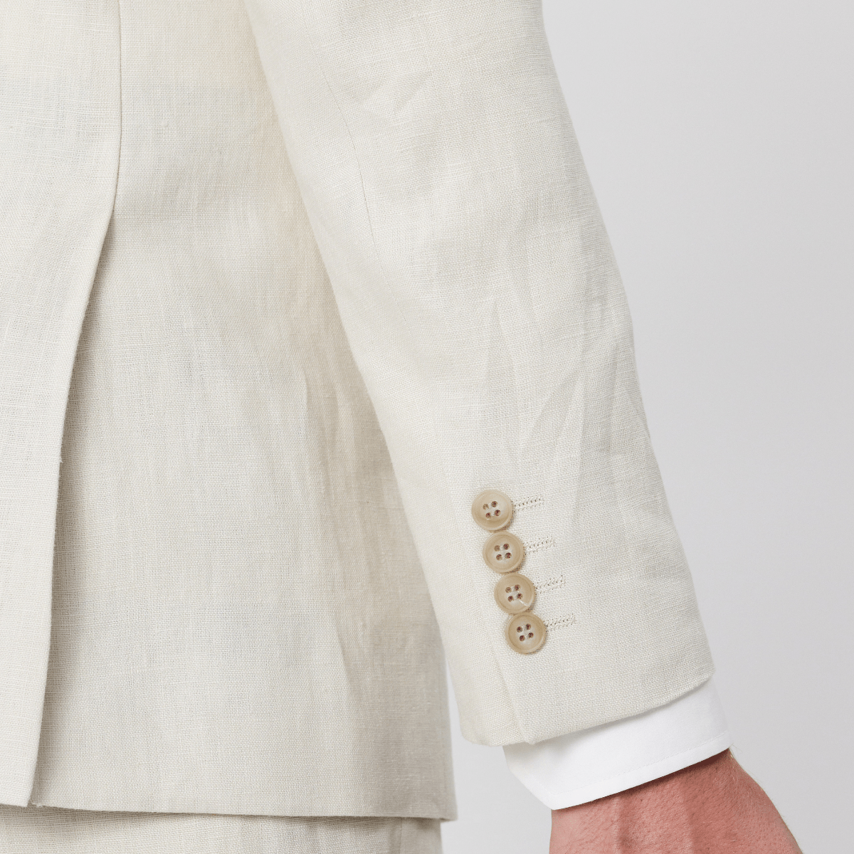 Cuffs and buttons on the mens single breasted, pure linen suit in ecru by Savile Row.