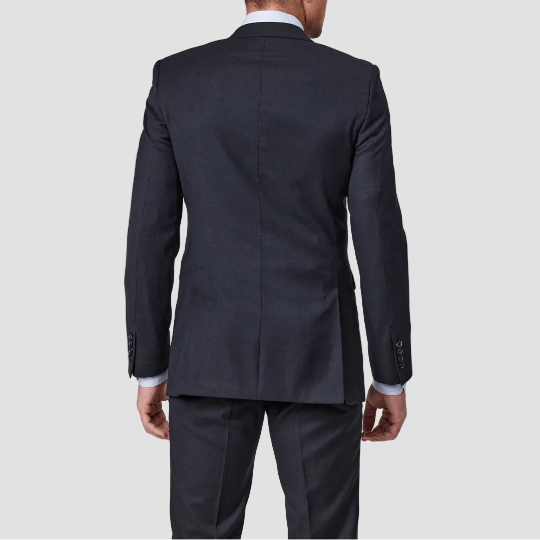 Man wearing a charcoal wool blend suit by Savile Row, double vented and four buttoned cuffs.
