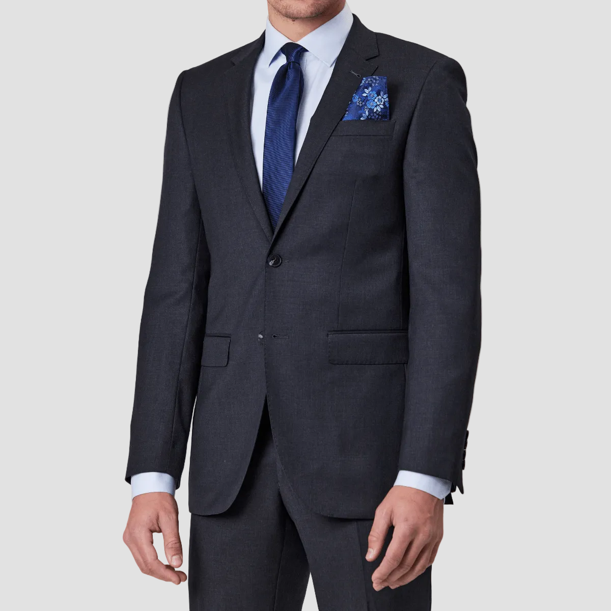 Charcoal wool blend suit by Savile Row with a blue tie and pocket square.